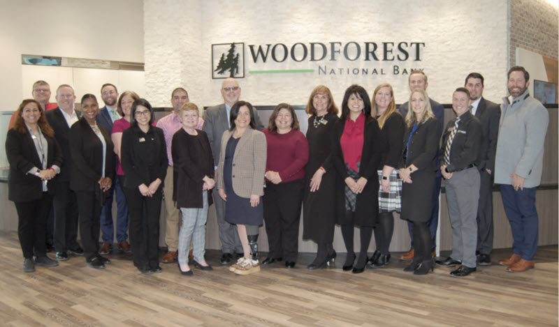 Bank employees gather with representatives from The City of Conroe and the Conroe - Lake Conroe Chamber of Commerce during the soft opening of the newly re-built Woodforest National Bank building in Downtown Conroe. Photo by Liz Grimm.